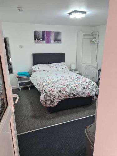 a small bedroom with a bed and a dresser at Cosy Studio - Town centre flat with free nearby parking in Shrewsbury