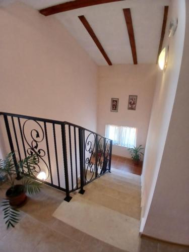a staircase in a house with a black railing at Guest rooms Bansko in Bansko