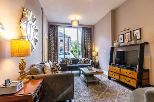 a living room with a couch and a tv at No 1 - Laurel Cottage - Pass the Keys in York