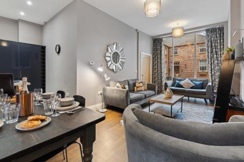 a living room with a table and some chairs at No 1 - Laurel Cottage - Pass the Keys in York