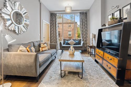 a living room with a couch and a tv at No 1 - Laurel Cottage - Pass the Keys in York