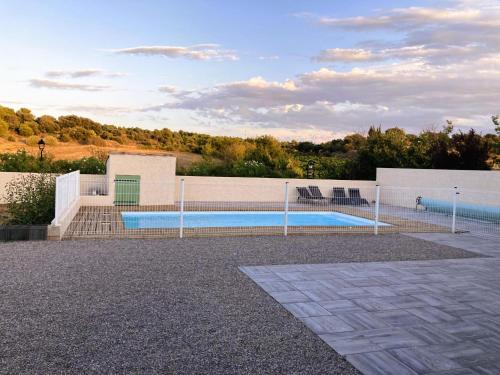 une piscine entourée d'une clôture dans l'établissement Lily, à Escales