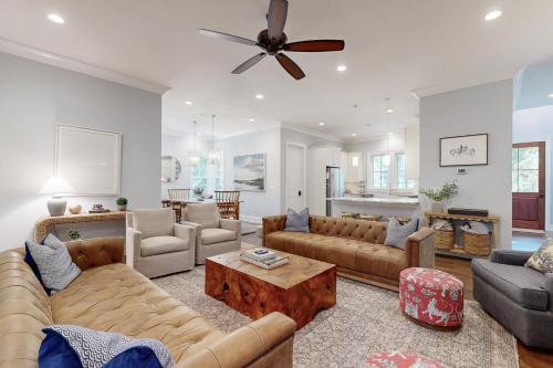 a living room with couches and a table at The Ocean Hideaway in Seabrook Island
