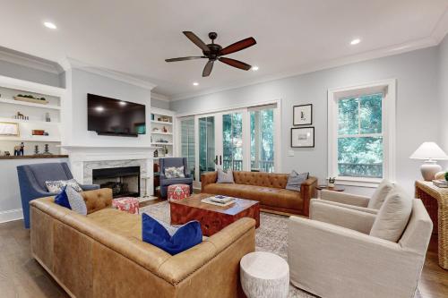 a living room with two couches and a fireplace at The Ocean Hideaway in Seabrook Island