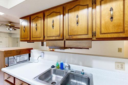 a kitchen with a sink and wooden cabinets at Sierra Serenity Retreat in Sierra Vista