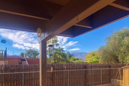 a porch with a wooden fence with a clock on it at Sierra Serenity Retreat in Sierra Vista