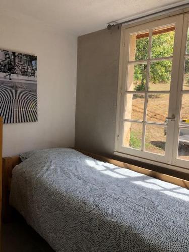 - une chambre avec un lit à côté d'une fenêtre dans l'établissement Lascaux Countryside Gite sleeping 7 people - Montignac Lascaux, à Brenac