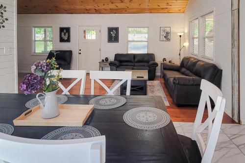 a living room with a table and a couch at Deer Retreat in Kodak
