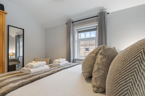 a bedroom with a bed with towels on it at No 3 - Lime Tree Cottage - Pass the Keys in York