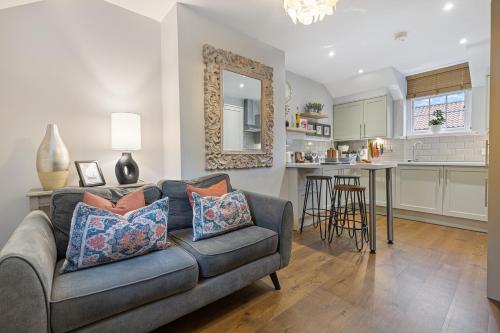 a living room with a couch and a kitchen at No 3 - Lime Tree Cottage - Pass the Keys in York