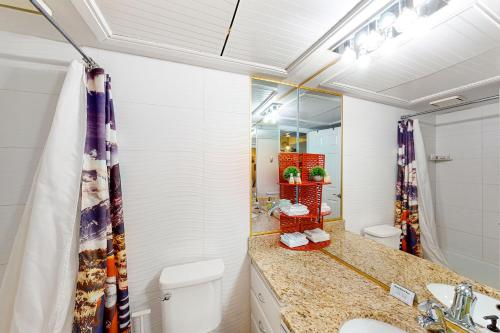 a bathroom with a toilet and a sink and a mirror at Desert Oasis at Sports Village- Unit W4 in St. George