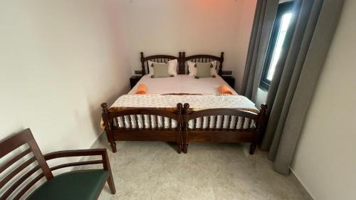a bedroom with a wooden bed and a window at Hotel Rising Star in Pushkar