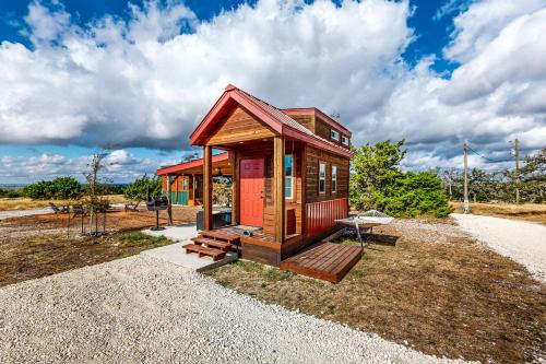 a tiny house sitting on top of a pile of gravel at Cabins on the Ranch in Harper