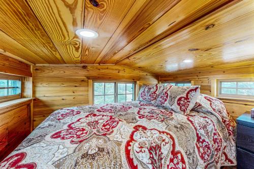 a bedroom with a bed in a wooden room at Cabins on the Ranch in Harper