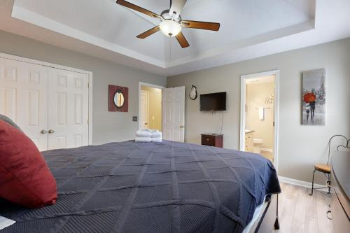a bedroom with a large bed with a ceiling fan at Mount Juliet Charmer in Hunters Store