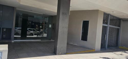a view of a building with glass windows and a parking lot at Palermo Apart 3 in Buenos Aires