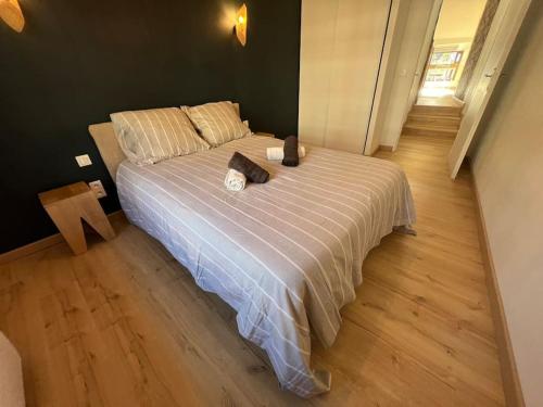 une chambre avec un lit avec une couette blanche dans l'établissement L'Écrin Cosy T2 Hypercentre, à Limoges