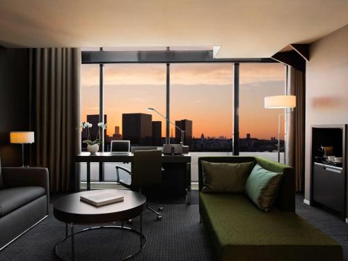 a living room with a view of a city skyline at Pullman Paris Centre - Bercy in Paris
