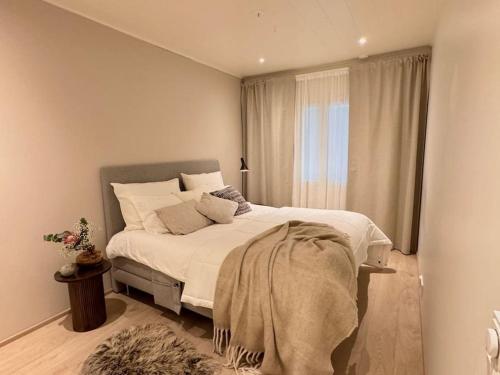 a bedroom with a large bed with a window at Villa Muru in Rovaniemi