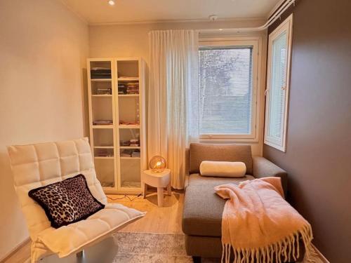 a living room with a couch and a chair at Villa Muru in Rovaniemi