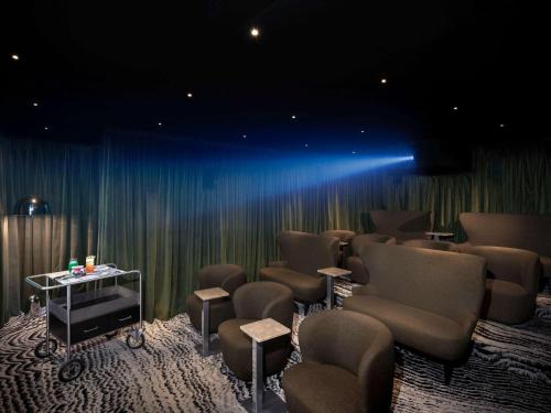 a waiting room with chairs and a table and lights at Pullman Paris Centre - Bercy in Paris