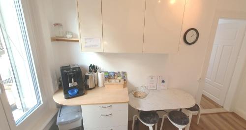 a kitchen with a counter with a coffee maker on it at 2-4 Zimmer Apartments Stilvoll im Gertrud Schlössli - zentral ruhig in St. Gallen