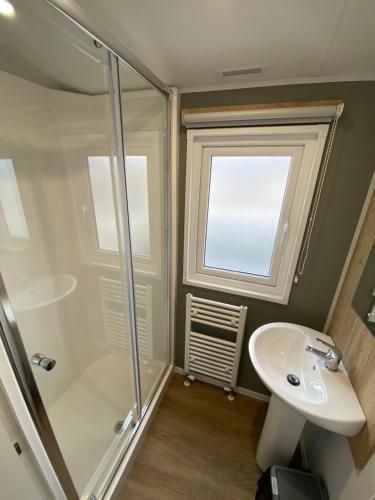 a bathroom with a shower and a sink at 3 Bedroom - Stunning Caravan in Coastal Eyemouth in Eyemouth