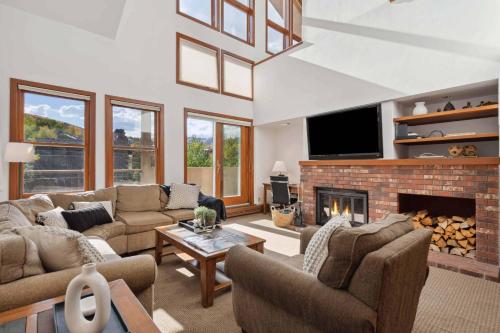 a living room with couches and a fireplace at Woodrun Place 56 in Snowmass