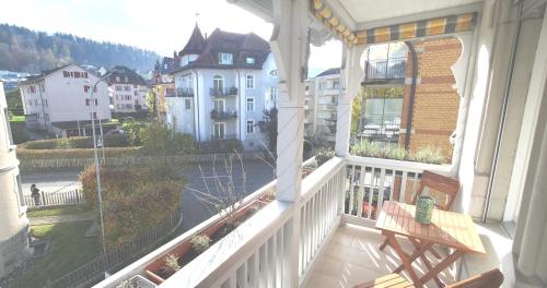 a balcony with a bench and a view of a city at 2-4 Zimmer Apartments Stilvoll im Gertrud Schlössli - zentral ruhig in St. Gallen