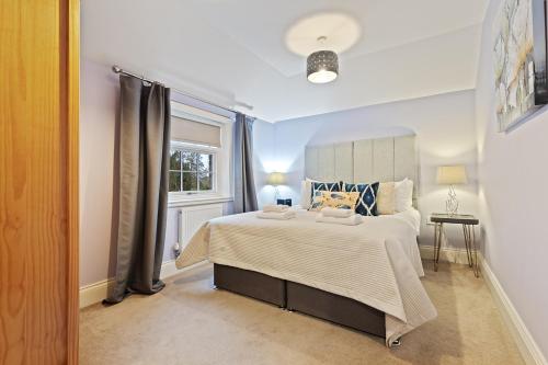 a bedroom with a large bed and a window at No 6 - Wisteria Cottage - Pass the Keys in York