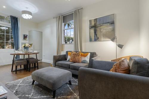 a living room with two couches and a table at No 6 - Wisteria Cottage - Pass the Keys in York