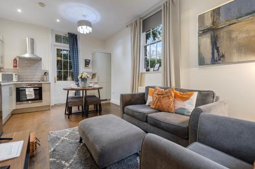 a living room with a couch and a table at No 6 - Wisteria Cottage - Pass the Keys in York