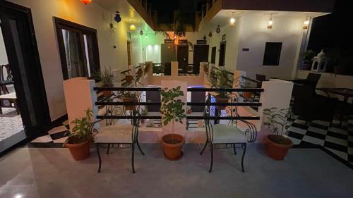 a patio with a table and chairs and plants at Hotel Rising Star in Pushkar