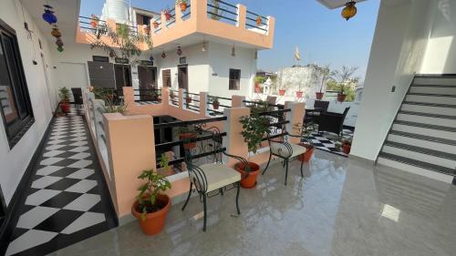 a balcony with chairs and plants on a building at Hotel Rising Star in Pushkar