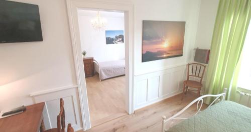 a room with a bedroom with a bed and a mirror at 2-4 Zimmer Apartments Stilvoll im Gertrud Schlössli - zentral ruhig in St. Gallen
