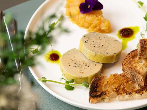 a plate of food with cheese and bread on a table at Pullman Paris La Défense in Courbevoie