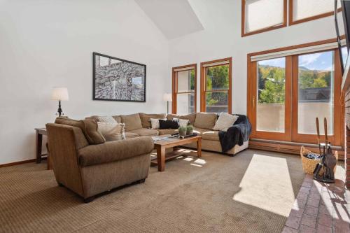 a living room with a couch and a table at Woodrun Place 56 in Snowmass