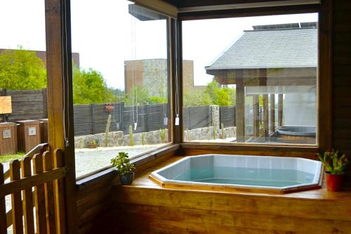 a bath tub in a room with a window at Altos de Pichilemu in Pichilemu
