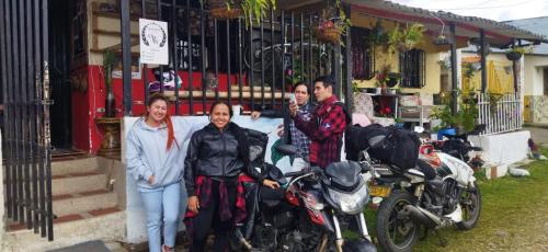 a group of people standing next to a motorcycle at Terracota Mirador Filandia in Filandia