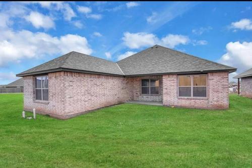 a brick house with a green lawn at Come n find out! Breathtaking! in Lawton