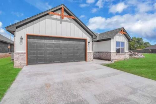 a large white garage with a large driveway at Come n find out! Breathtaking! in Lawton