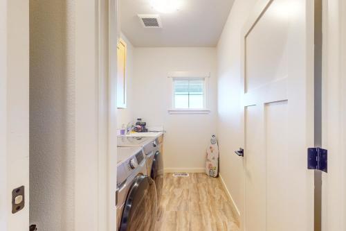 a kitchen with a sink and a washing machine at Heaven on Hemlock in Union