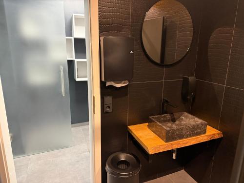 a bathroom with a sink and a mirror at reiminski Abenteuer Space Kapseln, Tennis Squash Soccer, Sport & Wellness in Bergen
