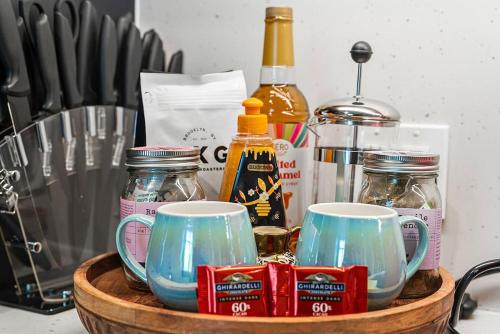a wooden basket with cups and other items on a counter at Family Friendly Boston Suite in Cambridge