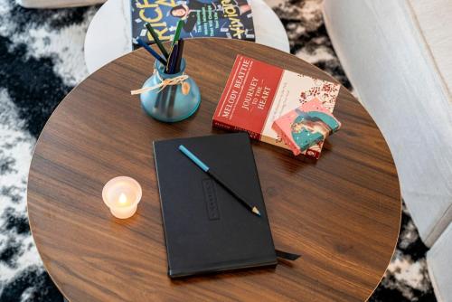a table with a notebook and a book and a candle at Family Friendly Boston Suite in Cambridge