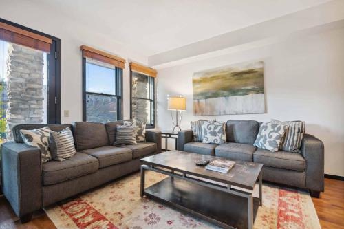 a living room with two couches and a coffee table at Woodrun Place 36 in Snowmass