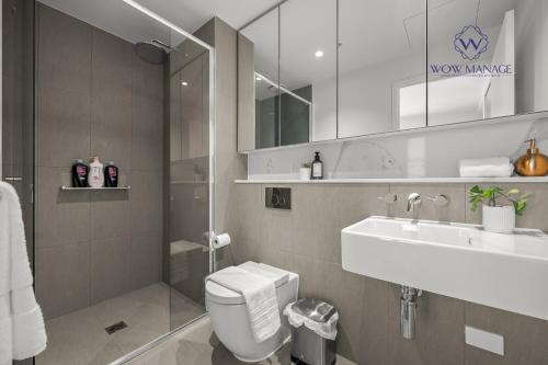 a bathroom with a toilet and a sink and a mirror at WOW Apartment on Hancock Southbank in Melbourne
