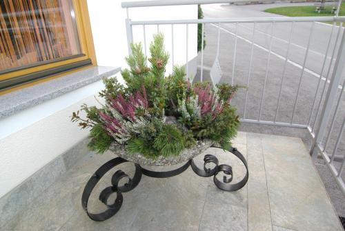 a planter with flowers in it on a balcony at Haus Binder in Ried im Zillertal