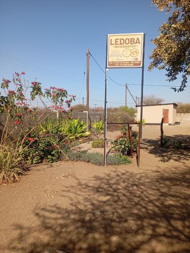 a sign in the middle of a dirt road at Ledoba Bed & Breakfast in Molalatau