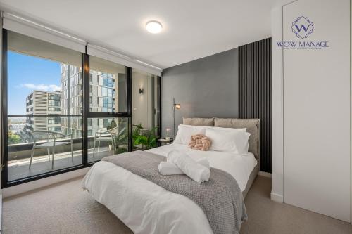 a bedroom with a bed with a teddy bear on it at WOW Self-Contained Apartment on Hall in Melbourne